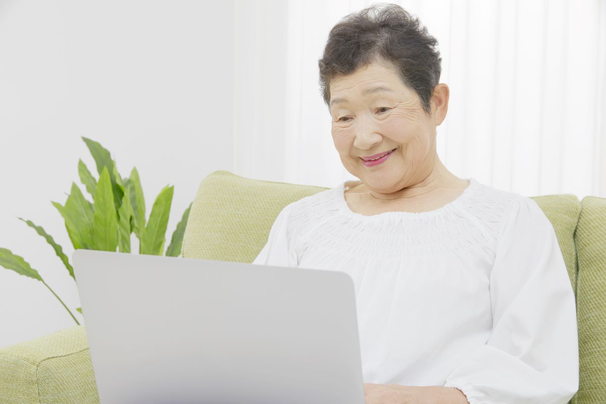 PCを操作する高齢女性の写真